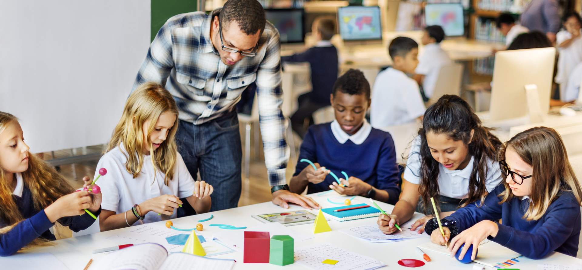 Teacher helping with a project