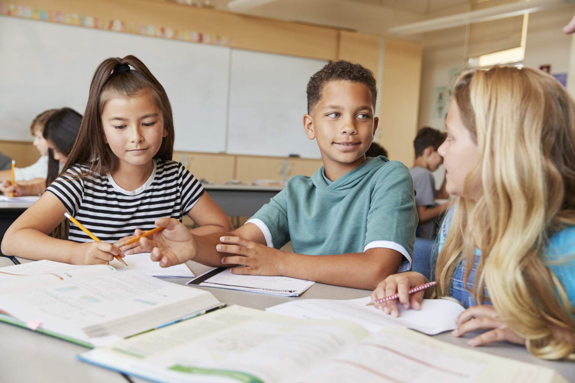 Students at a table with textbooks open